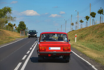 POLAND. Retro car.  Red Fiat with balls inside the cabin Wedding - obrazy, fototapety, plakaty