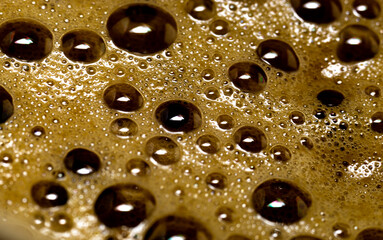 brown foam with bubbles on coffee