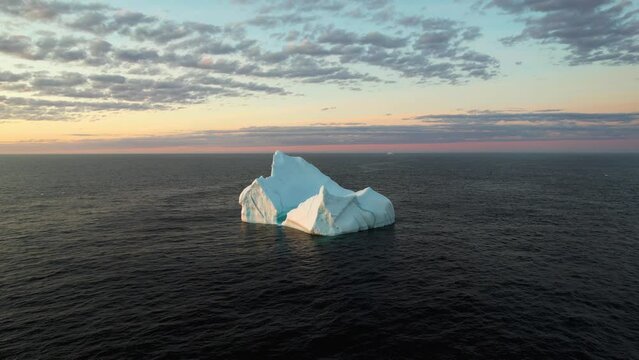 Iceberg on the open ocean at sunrise