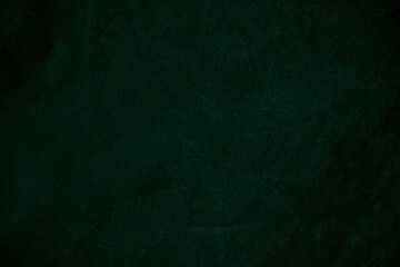 Dark green old velvet fabric texture used as background. Empty green fabric background of soft and smooth textile material. There is space for text...