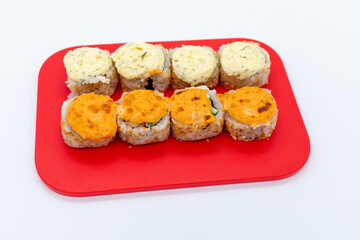 Set of hot maki sushi on cutting board on white background