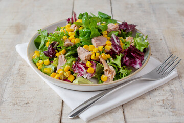 Healthy Green salad with tuna, lettuce, corn and olive oil
