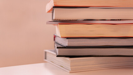 Close-up of a stack of hardback books on a table