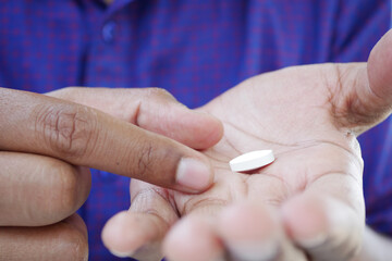 Close up of man hand holding pills with copy space 