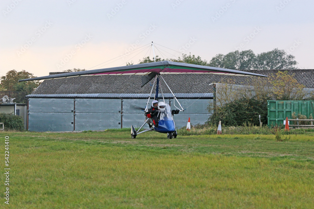 Poster ultralight airplane taxiing on a farm strip