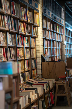 image of books piled in second-hand bookcase background