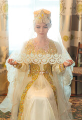 Uzbek bride sitting in national dress