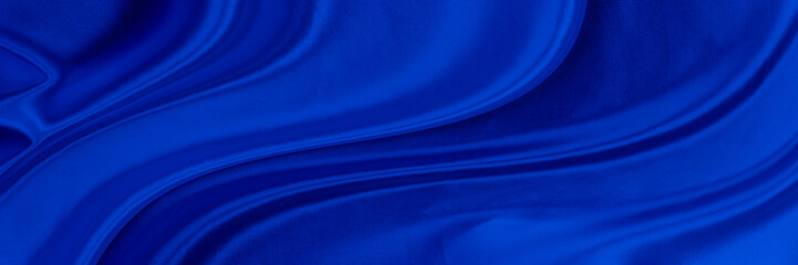 Black blue satin dark fabric texture luxurious shiny that is abstract silk cloth background with patterns soft waves blur beautiful.