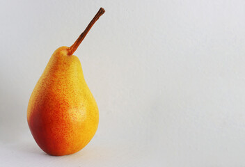 Red-yellow pear close-up on a white background.