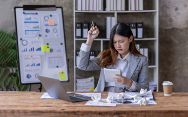 Young business Asian women are stressed while working on laptop phone Tired asian businesswoman with headache at office, feeling sad or sick at work copy space in workplace office.