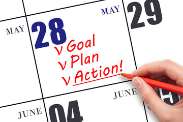 Hand writing text GOAL PLAN ACTION  on calendar date May 28. Motivation for a new day. Business...