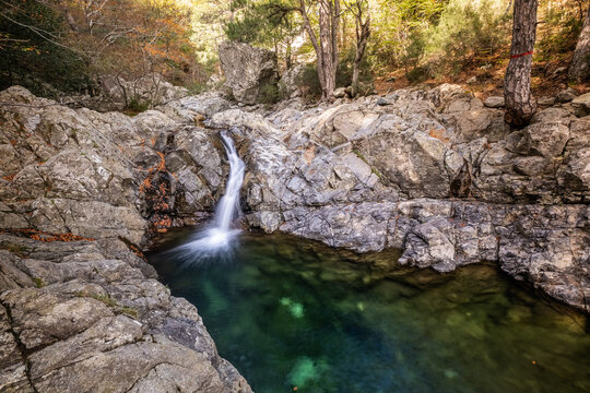 L'Agnone river cascades over rocks into a natural pool in the forest of Vizzavona alongside the GR20 trail in Corsica