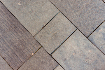 Modern cobblestone pavement surface of a sidewalk as urban backdrop