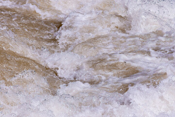 Close up to water foam texture in the rapid section of a river