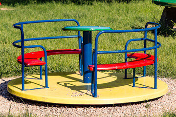 Empty carousel with bench as seat in a park for kids