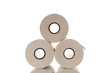 Three rolls of paper cash register tape, close-up isolated on white.