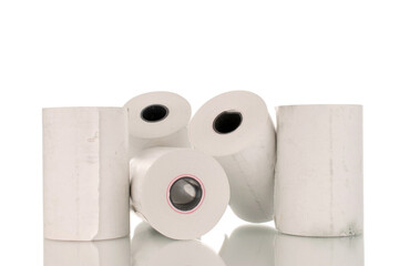 Several rolls of paper cash register tape, close-up isolated on white.