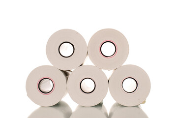 Several rolls of paper cash register tape, close-up isolated on white.