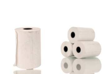 Several rolls of paper cash register tape, close-up isolated on white.