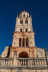 Bell Tower of Santa María del Campo Church in Burgos, Spain, with Clear Blue Sky