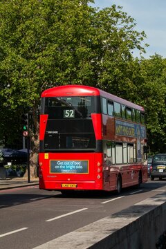 Vertical shot of the back of a red double-decker bus in London on a sunny day