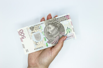 Polish 500 złoty banknote held in the hand against a white background	
