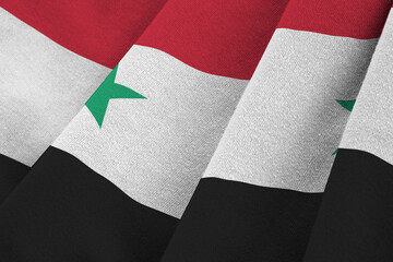 Syria flag with big folds waving close up under the studio light indoors. The official symbols and...