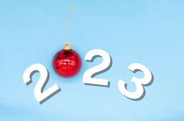 
christmas 2023 on blue background with a red christmas ball replacing the 0. new year concept, copy space, merry christmas, edited image