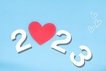 2023 on blue background with a heart replacing the 0. concept of new year, copy space, cardio...