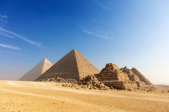 Egypt. Cairo - Giza. General view of pyramids from the Giza Plateau three pyramids known as Queens Pyramids on front side next in order from left: the Pyramid of Menkaure, Khafre and Chufu.
