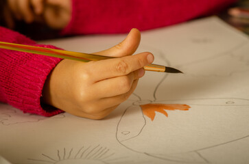 The child paints a picture. Education, inspiration, joy.