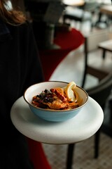 Vertical closeup of delicious food with slice of lemon in a restaurant
