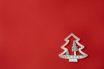 Naklejka na ściany i meble small white figures of a Christmas tree on a red background with a place for text, Christmas concept, gifts,sale