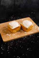 Lemon cakes with icings on a wooden table