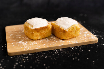 Lemon cake with frosting on a wooden table
