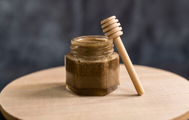 Obraz na płótnie Canvas Homemade honey with honey spoon