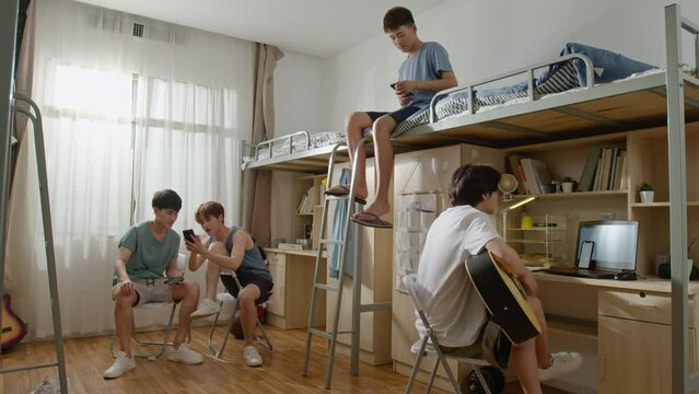 Young Chinese university students relaxing in dormitory,4K