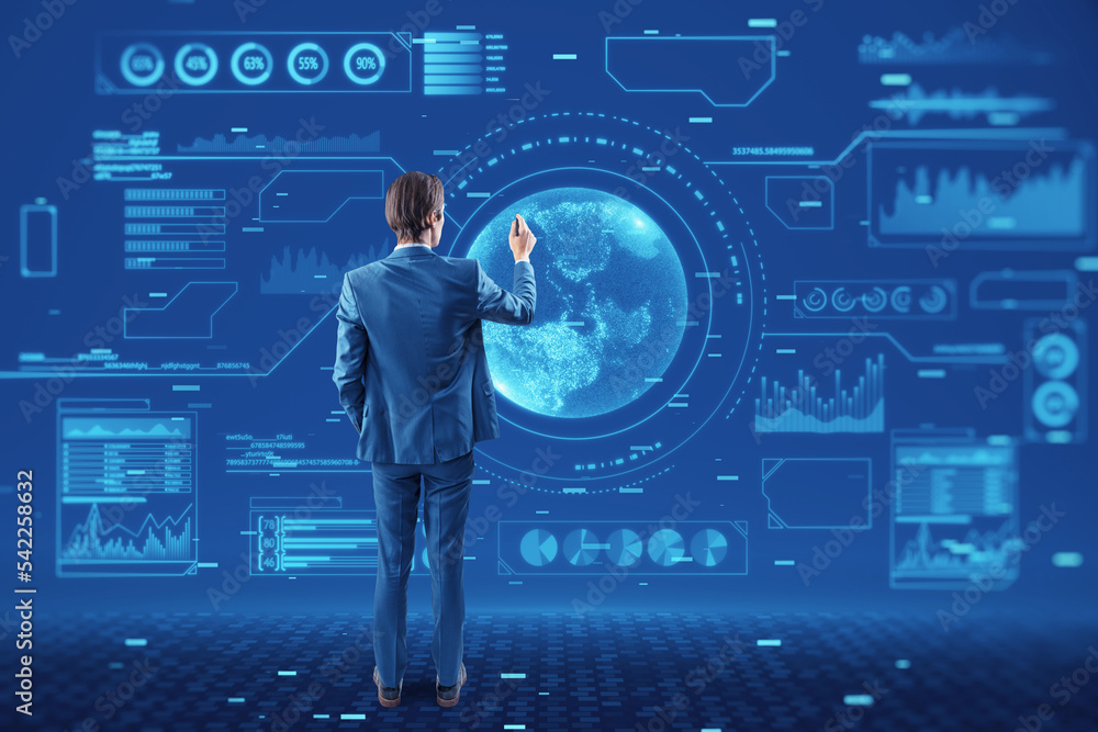 Poster Back view of young european businessman using abstract glowing digital business interface with globe and various other icons. Tech, future and economy concept.