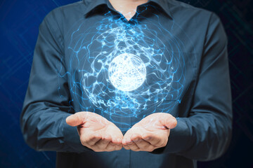 Close up of male hands holding glowing blue linear sphere on blurry background. Geometric...