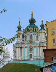 Fototapeta na wymiar The blue facade of the Church of St. Andrew in Kyiv against the background of the blue sky. Andriyivskyi Uzviz in Kyiv. Architectural monument. Religious buildings.
