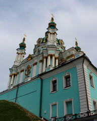 Fototapeta na wymiar The blue facade of the Church of St. Andrew in Kyiv against the background of the blue sky. Andriyivskyi Uzviz in Kyiv. Architectural monument. Religious buildings.