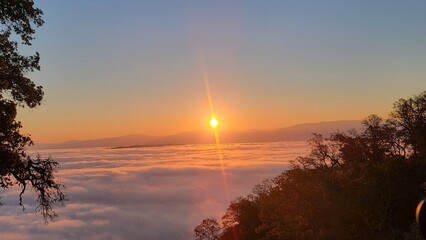 sunrise over the mountains above the clouds