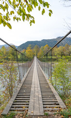 Fototapeta na wymiar rope bridge over the river in autumn