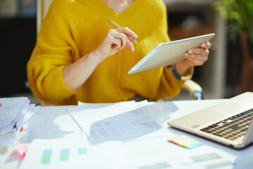 Business owner woman using tablet PC and working with documents