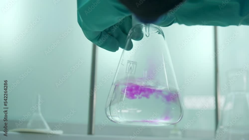 Aufkleber close-up of flask with chemical liquid. clip. laboratory assistant conducts experiments with chemica