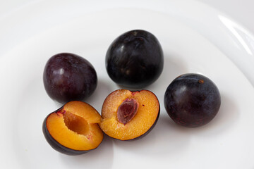 plums on a white plate