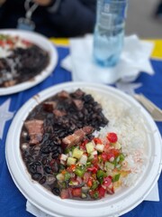 Typical brazilian food, feijoada. Beans with pork meat, rice and salad