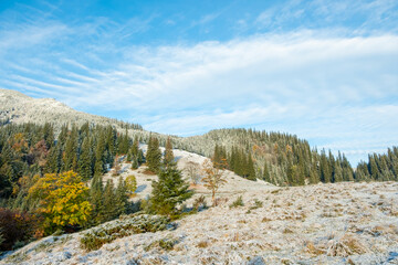 First snow cover field in mountain. Beautiful autumn morning