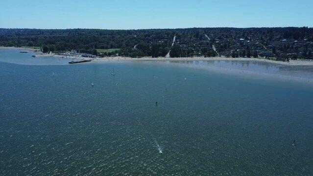 Aerial view of kite surfing in a blue sea  on Vancouver Spanish banks beach on a summer day