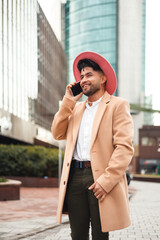 young colombian stylish man using smartphone, vertical shot